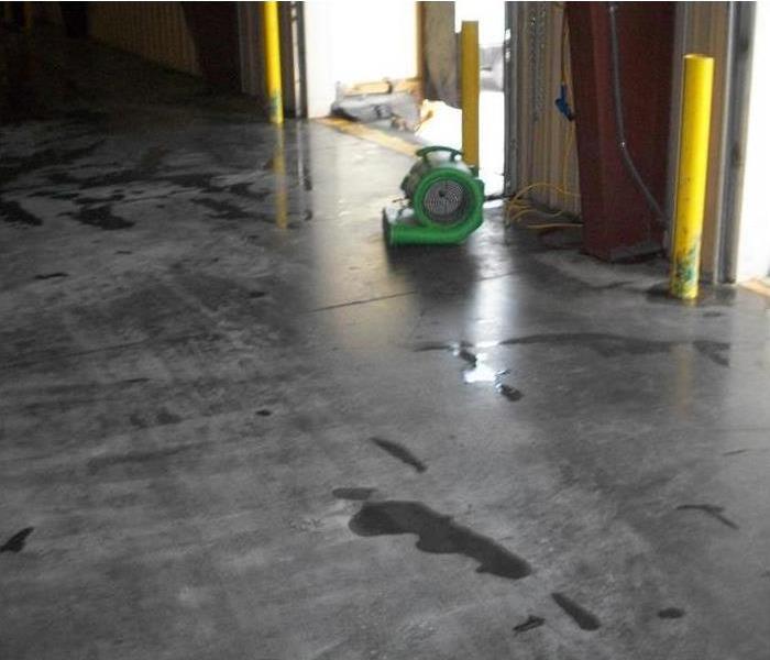 air mover on concrete floor by bay door opening