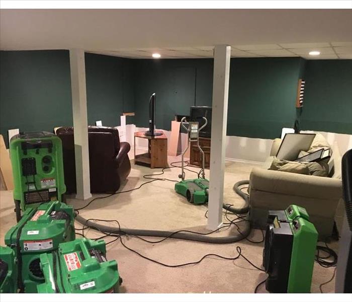 view of room, furniture, and many green gear drying the area