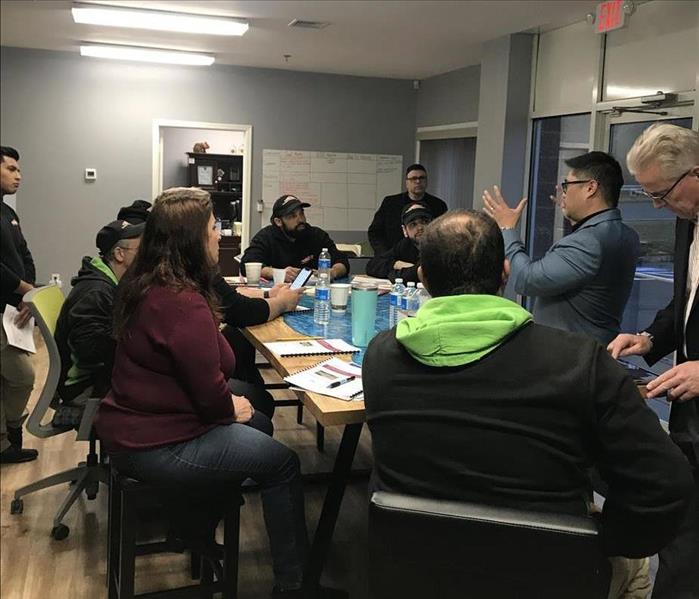 SERVPRO technicians meeting around a table