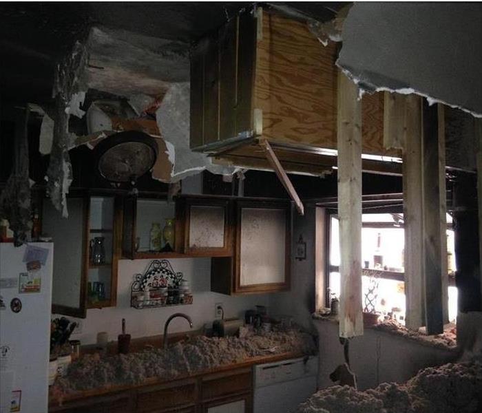 ripped open ceiling, insulation on the counters, hint of fire damage