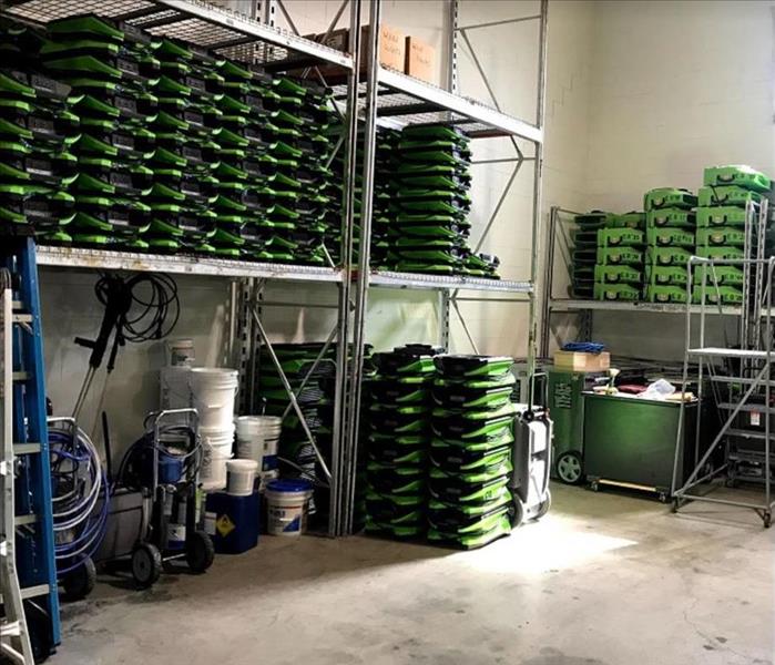 inside SERVRO storage facility; restoration equipment stacked on shelves